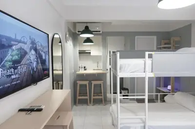 a room with a bedroom with bunk beds and a tv at Dragonfly Apartments and Transient House in Bacoor