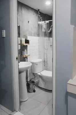 a bathroom with a toilet and a sink at Dragonfly Apartments and Transient House in Bacoor