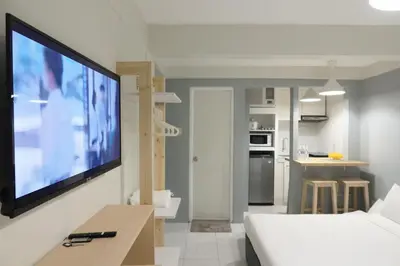 a living room with a large flat screen tv on a wall at Dragonfly Apartments and Transient House in Bacoor