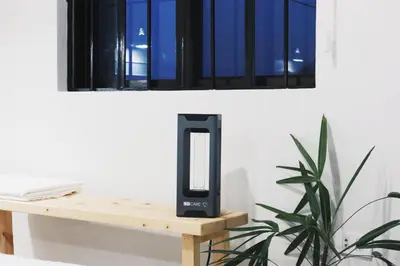 a black iphone speaker sitting on a table next to a window at Dragonfly Apartments and Transient House in Bacoor