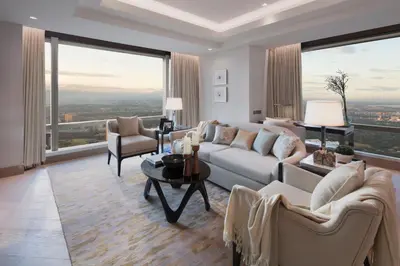 a living room with a couch and chairs and large windows at Shangri-La Residences The Fort, Manila in Manila