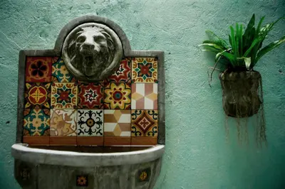 a wall with a picture of a face on a tile at Charming La Casita Mercedes, 5Br and 5TB for Family and Friends Staycation- Read Listing Info in Manila