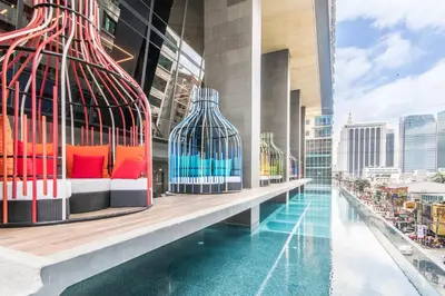 a building with a pool with a bird cage on it at I'M Hotel in Manila