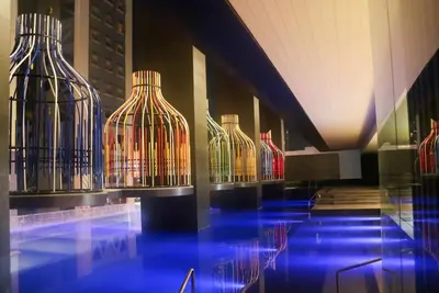 a row of wine bottles on display in a building at I'M Hotel in Manila