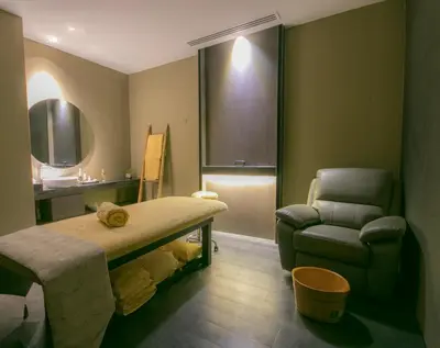 a hospital room with a bed and a chair at I'M Hotel in Manila