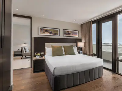 a bedroom with a bed and a view of the ocean at Somerset Alabang Manila in Manila