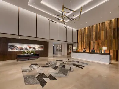 a lobby with a large rug on the floor at Somerset Alabang Manila in Manila