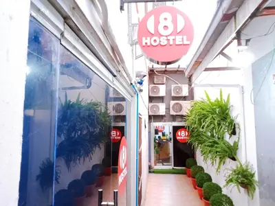 a hotel with a sign on the side of a building at 8Hostel in Manila