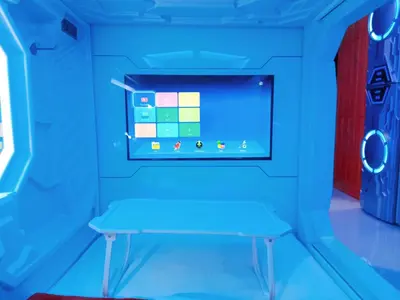 a blue room with a table in it at 8Hostel in Manila