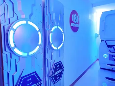 a bathroom with three round mirrors on the wall at 8Hostel in Manila