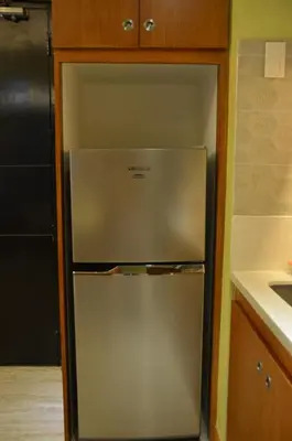 a refrigerator in a kitchen with its door open at A Homey Place At Adriatico in Manila