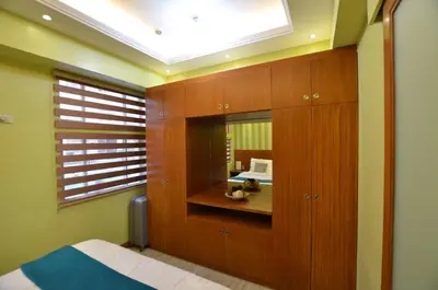 a bedroom with a mirror and a bed in it at A Homey Place At Adriatico in Manila