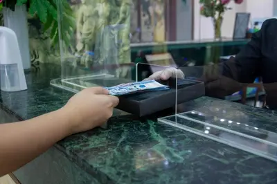a child is holding a remote control on a counter at Eurotel Vivaldi Araneta in Manila