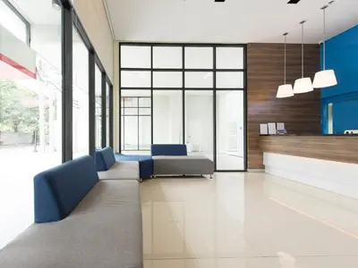 an office lobby with couches and tables and windows at Hop Inn Hotel Ermita Manila in Manila