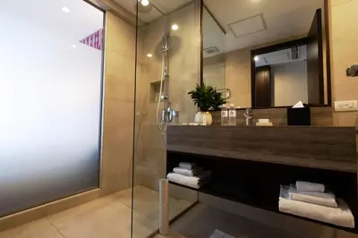 a bathroom with a sink and a mirror at Wynwood Hotel in Manila