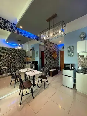 a kitchen and dining room with a table and chairs at The Beacon Residences Condominium in Manila