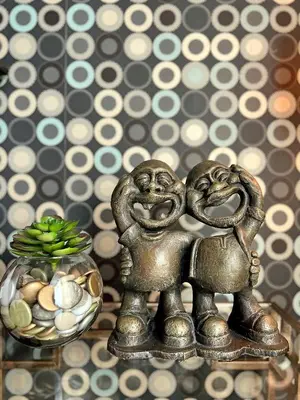 two metal figurines are standing next to a bowl of eggs at The Beacon Residences Condominium in Manila
