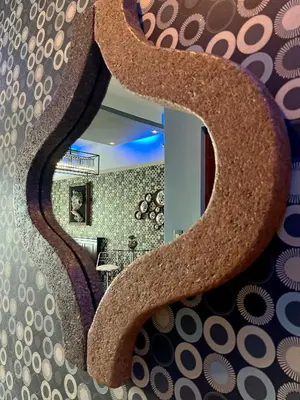 a bathroom with a large rock mirror on the wall at The Beacon Residences Condominium in Manila