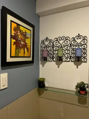 a room with three lights on a wall with a picture at The Beacon Residences Condominium in Manila