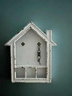 a white house hanging on a wall with a hook at The Beacon Residences Condominium in Manila