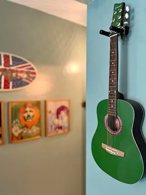 a green guitar hanging on a wall at The Beacon Residences Condominium in Manila