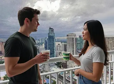 a man and a woman standing on a balcony with drinks at All At Jazz - Makati Serviced Apartments in Manila