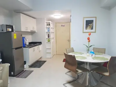 a kitchen and dining room with a table and chairs at All At Jazz - Makati Serviced Apartments in Manila