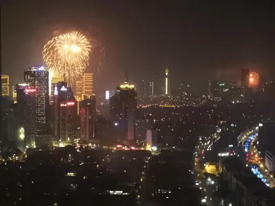 a city skyline at night with fireworks in the sky at All At Jazz - Makati Serviced Apartments in Manila