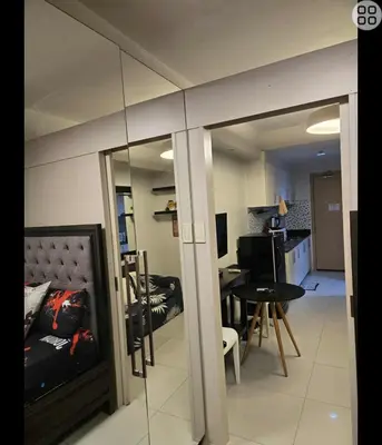 a living room with a couch and a table at FinkSea @ Sea Residences in Manila