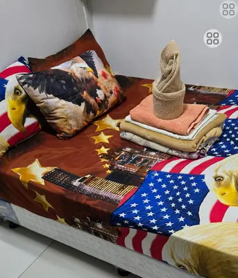 a bed with an american flag and patriotic blankets at FinkSea @ Sea Residences in Manila