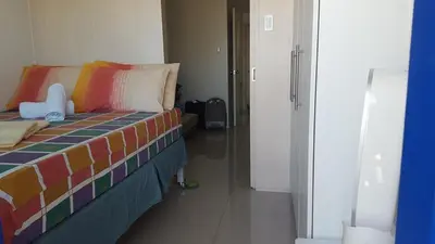 a room with a bed with a colorful blanket at FinkSea @ Sea Residences in Manila