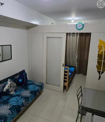 a small room with a bed and a door at FinkSea @ Sea Residences in Manila