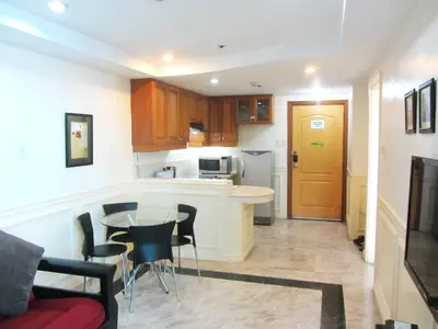 a small kitchen with a table and chairs in a room at Baywatch Tower in Manila