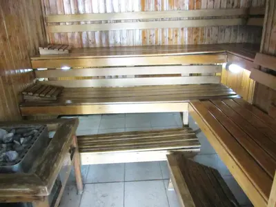 an empty sauna with wooden benches in a room at Baywatch Tower in Manila