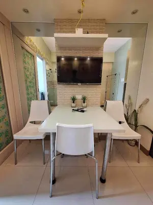 a conference room with a white table and chairs at Sea Residences MOA-Eric Apartments in Manila