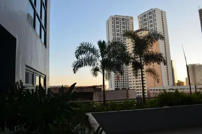 a view of a city with palm trees and buildings at Eton Parkview in Manila