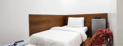 a hotel room with two beds and a backpack at Hotel Durban in Manila