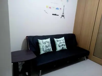 a blue couch with two pillows on it in a room at Condo At Shell Residences in Manila