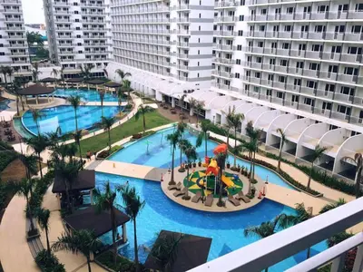 an aerial view of the pool at a resort at Condo At Shell Residences in Manila