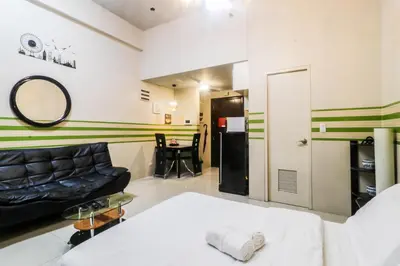a living room with a couch and a table at PRS at One Palm Tree Villa near T3 Airport in Manila