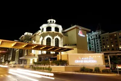 a large building with a clock tower at night at PRS at One Palm Tree Villa near T3 Airport in Manila