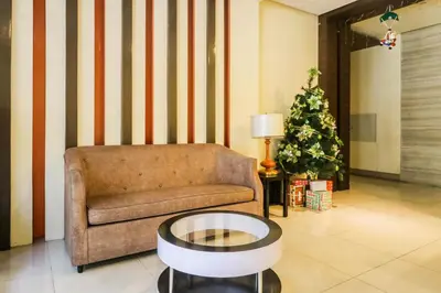 a living room with a couch and a christmas tree at PRS at One Palm Tree Villa near T3 Airport in Manila