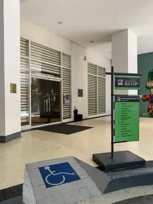 a sign in front of a building with a handicapped sign at Eastwood Residence Above Eastwood Mall in Manila