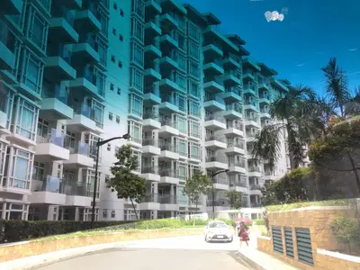 a car parked in front of a tall building at Condo at Parkside Villas across the airport in Manila