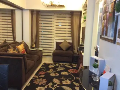 a living room with a couch and a chair at Condo at Parkside Villas across the airport in Manila