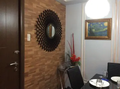 a room with a table and a mirror on the wall at Condo at Parkside Villas across the airport in Manila