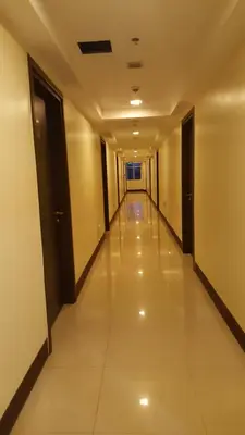 a long hallway in a building with a long floor at Suntrust Parkview Apartment in Manila
