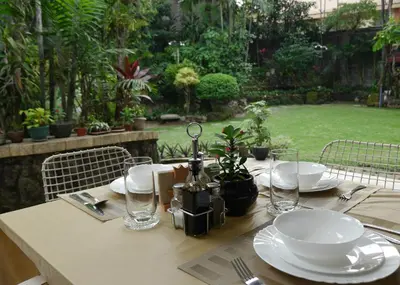 a table with plates and glasses on top of it at New Manila Suites in Manila