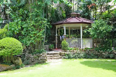 a gazebo in the middle of a garden at New Manila Suites in Manila