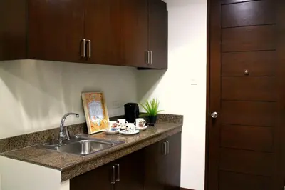 a kitchen with a sink and a counter top at Ortigas Budget Hotel - Kapitolyo in Manila